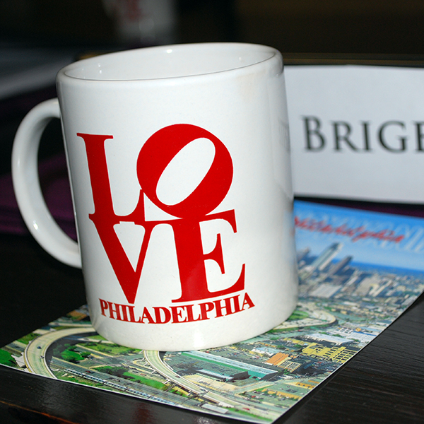 Philadelphia love mug, postcard, and convention binder.