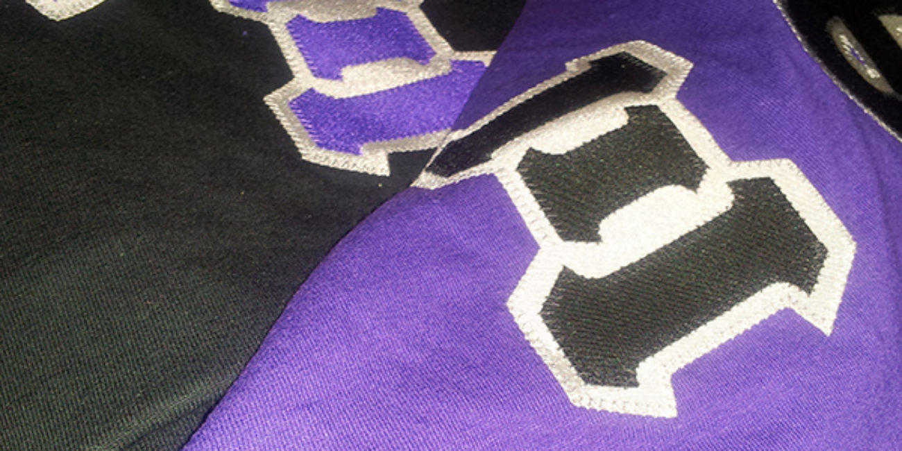 Black and purple Gamma Xi Phi t-shirts.